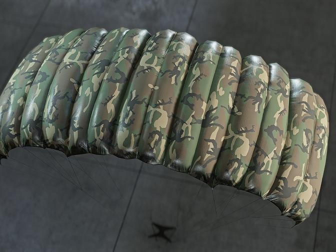 A parachute with a green camouflage pattern.
