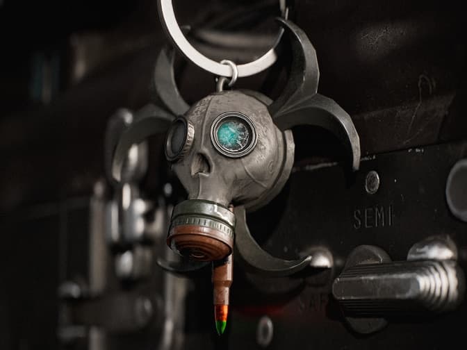 Gas mask keychain with biohazard blades.