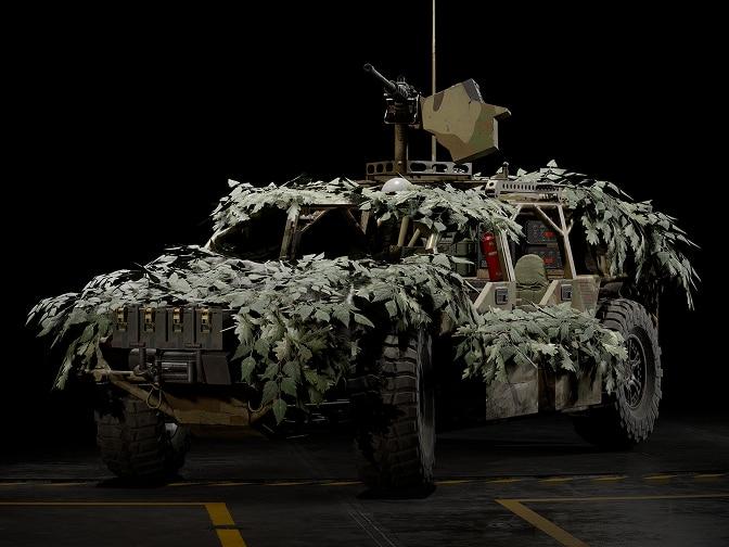 A light ground transport vehicle covered in leaves.